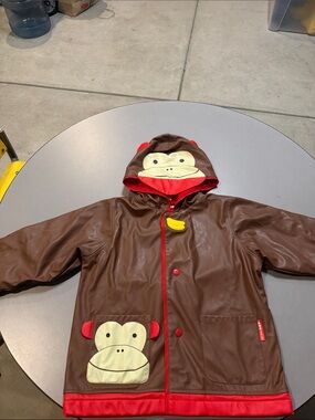 Skip Hop Brown Monkey Raincoat with Red Trim and Yellow Banana Accent
